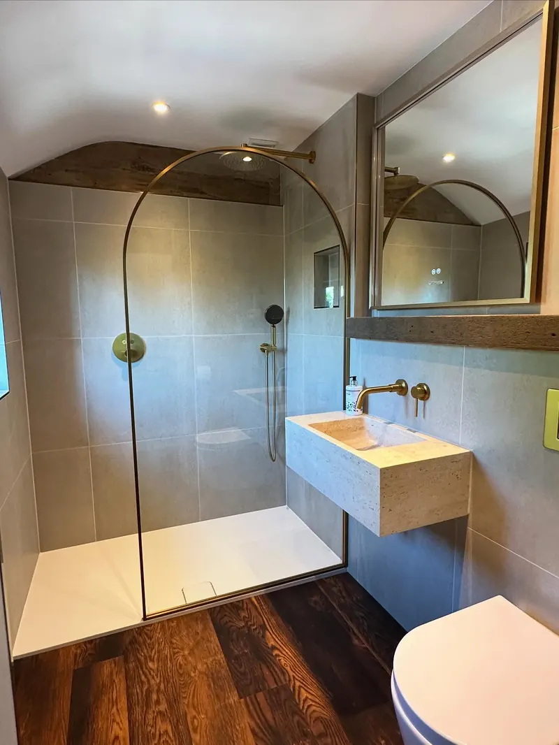A finished bathroom with an arched shower, fitted by Addisons