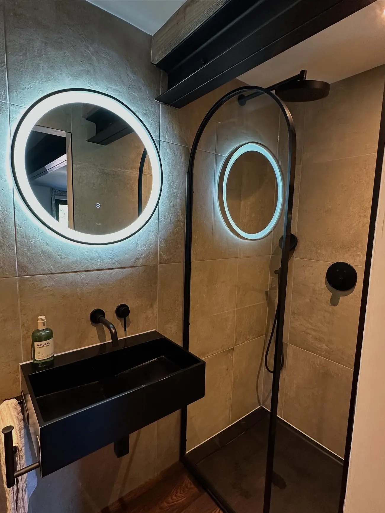 A bathroom with a black basin and taps, fitted by Addisons