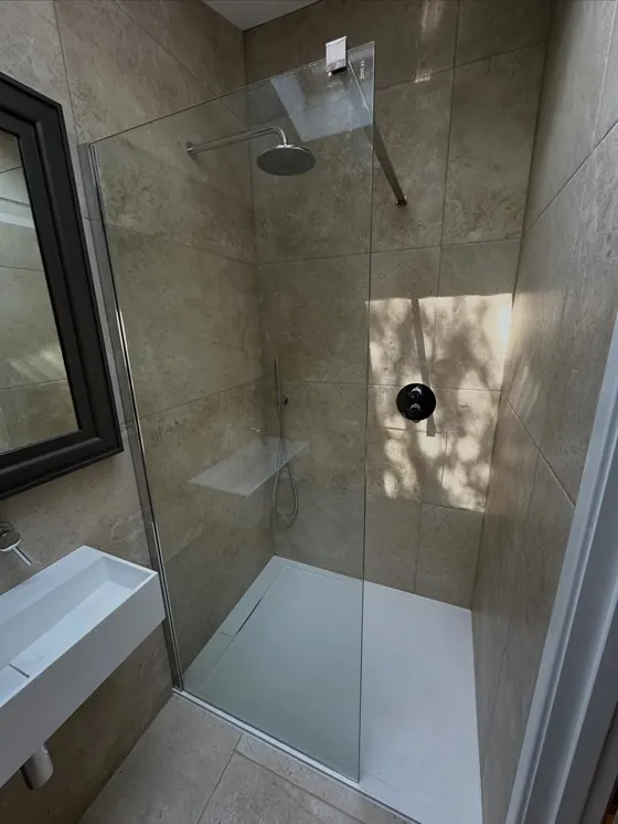 Walk-in shower with a frameless glass screen
